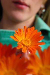 A women holding a flower.